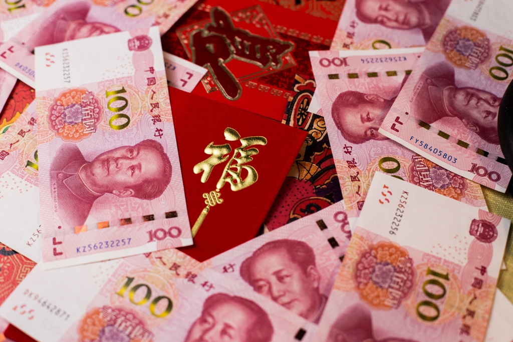 closeup_shot_of_100_chinese_yuan_cny_banknotes_and_chinese_traditional_red_envelop.jpg